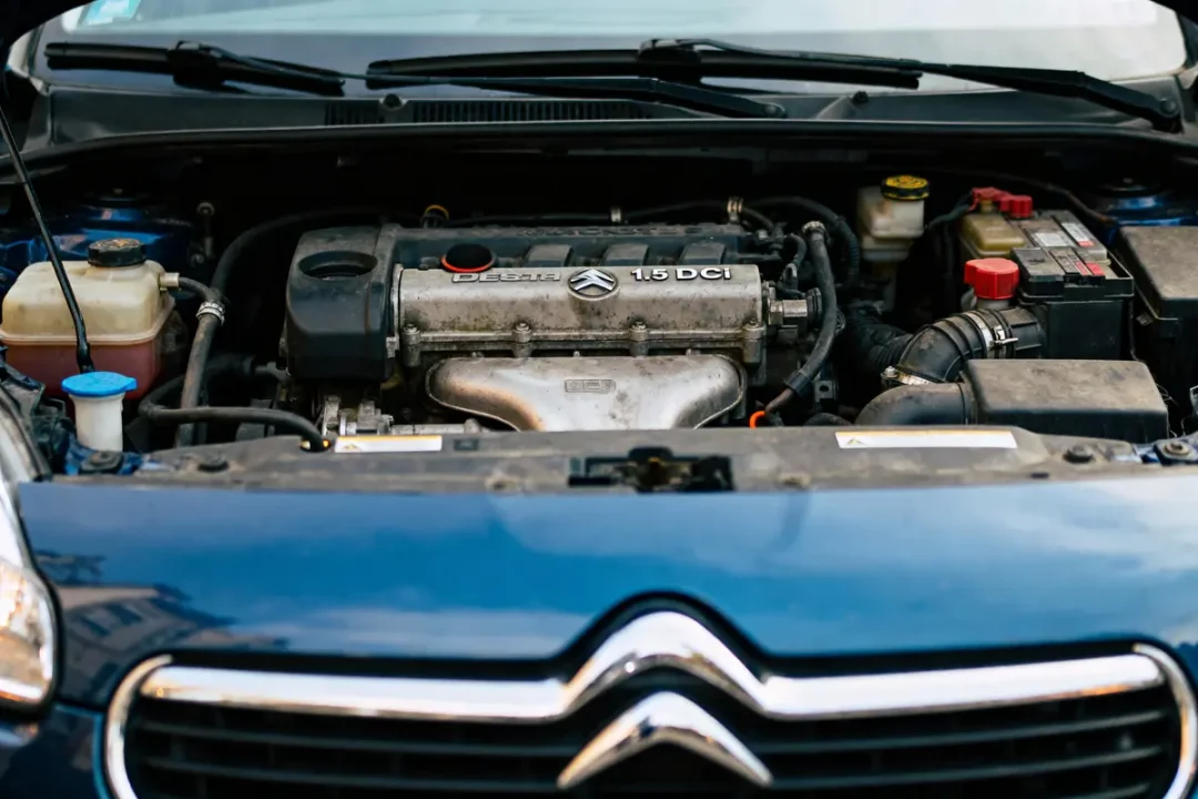 Compartiment moteur d'une voiture Citroën, avec badge Diesel 1.5 DCI visible, capot ouvert.